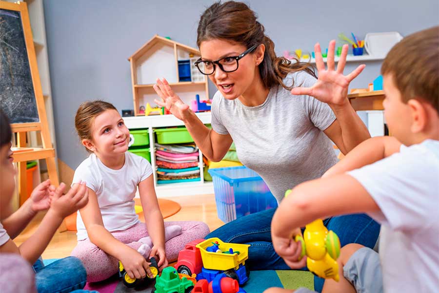 A preschool teacher engages a group of children